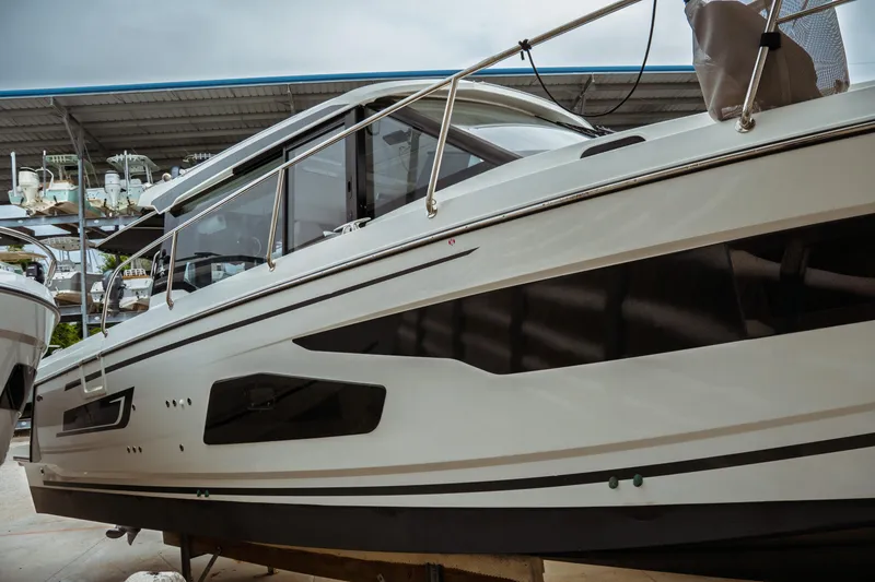 Slide: The Image of 2023 Jeanneau NC 1095 boat in storage, showcasing sleek design and modern features. - 5