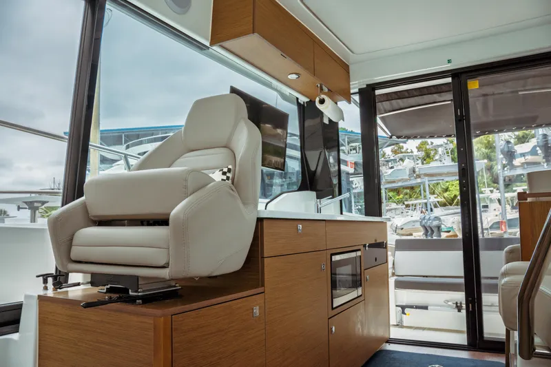 Slide: The Image of Interior of 2023 Jeanneau NC 1095 boat with modern helm and seating. - 53