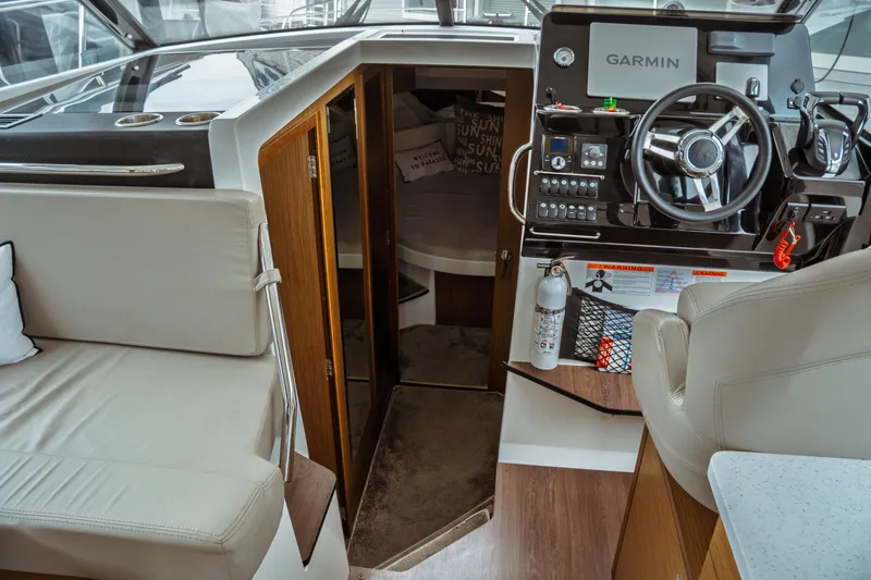 Slide: The Image of Interior of 2023 Jeanneau NC 1095 boat with helm, seating, and navigation equipment. - 55
