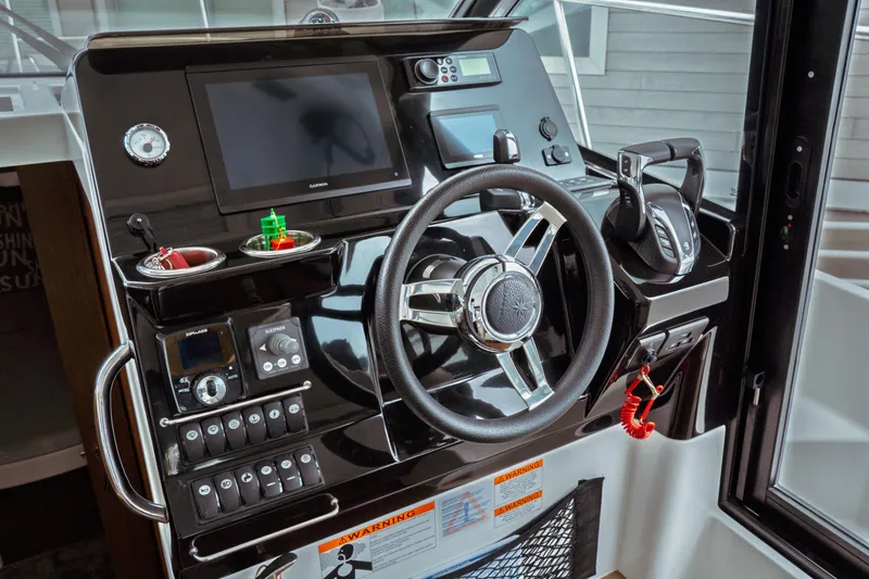 Slide: The Image of 2023 Jeanneau NC 1095 helm with modern controls and navigation equipment. - 58