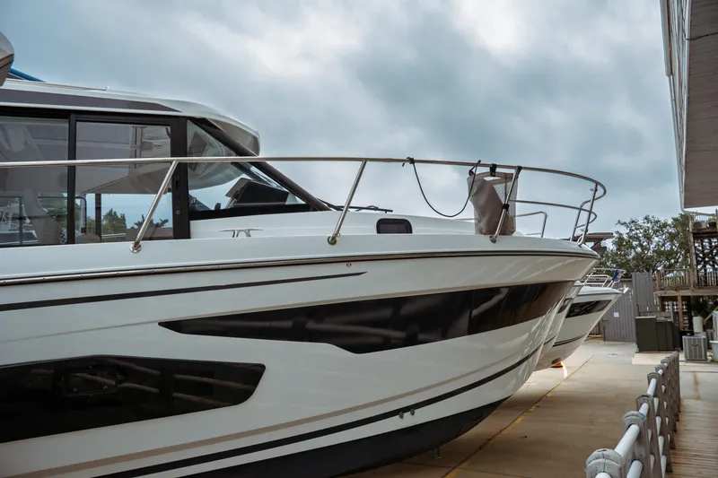 Slide: The Image of 2023 Jeanneau NC 1095 boat docked, showcasing sleek design and modern features. - 6