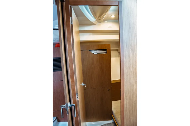 Slide: The Image of Interior view of 2023 Jeanneau NC 1095 boat cabin with wooden door and modern design. - 66