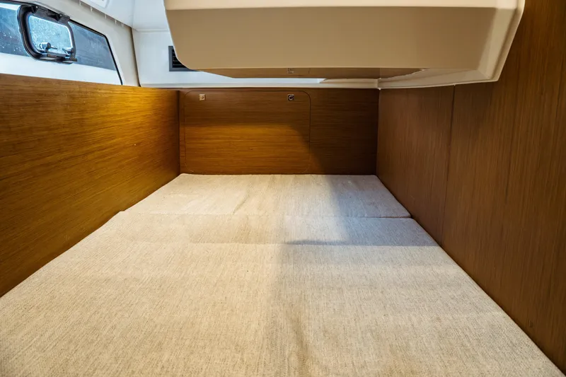 Slide: The Image of 2023 Jeanneau NC 1095 cabin interior with wood paneling and window. - 68