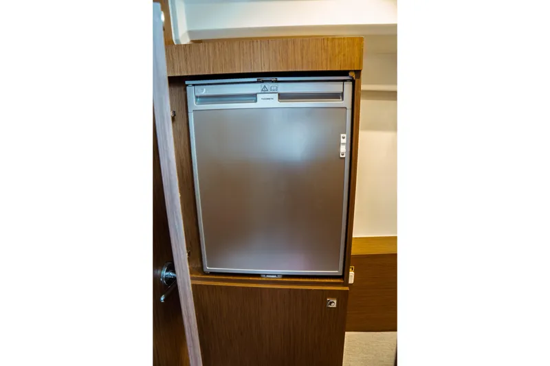 Slide: The Image of Compact refrigerator inside 2023 Jeanneau NC 1095 boat cabin. - 69