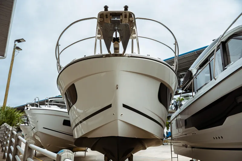 Slide: The Image of 2023 Jeanneau NC 1095 boat displayed in a marina, front view. - 7