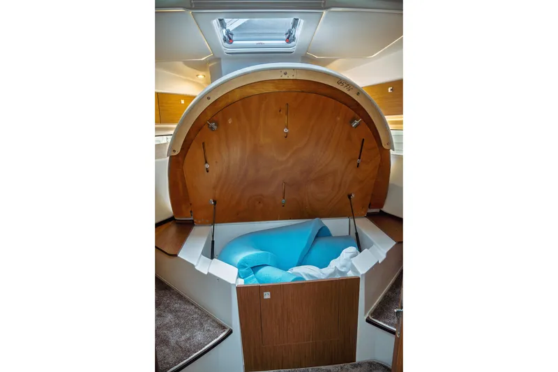 Slide: The Image of 2023 Jeanneau NC 1095 boat interior with open storage compartment. - 73