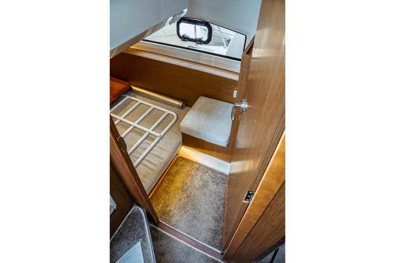 Slide: The Image of 2023 Jeanneau NC 1095 cabin interior with cozy bed and wooden finish. - 84