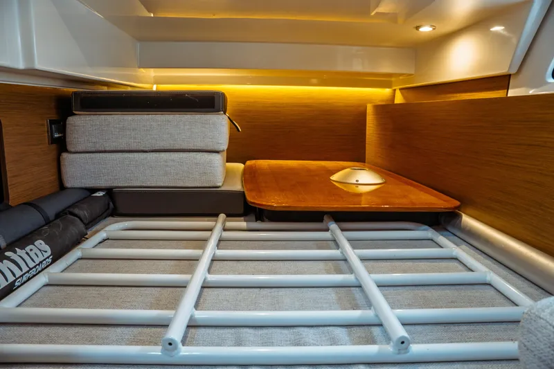 Slide: The Image of 2023 Jeanneau NC 1095 interior cabin with wooden table and cushioned seating. - 85