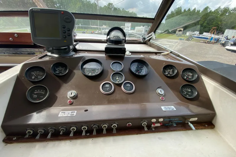 Slide: The Image of 1976 Slickcraft 28 Cruiser dashboard with gauges and navigation equipment. - 13