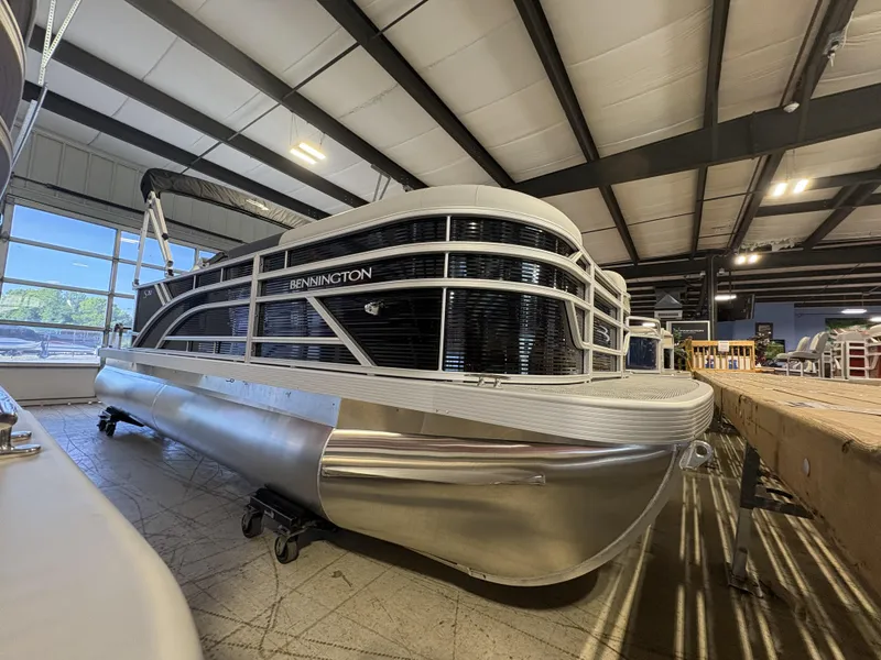 The Image of 2024 Bennington 20 SLSE pontoon boat displayed indoors, showcasing sleek design and modern features. - 1
