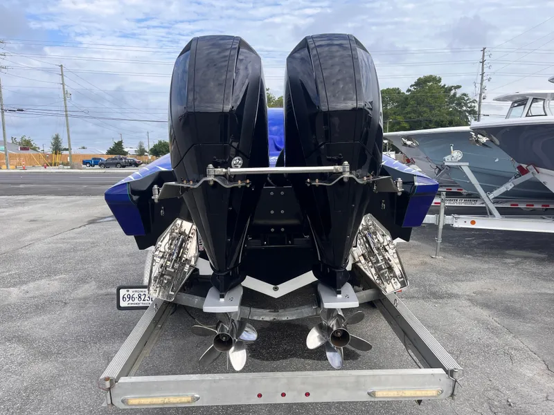 Slide: The Image of 2018 Lavey Craft 28 EVO boat with dual outboard motors on a trailer. - 4