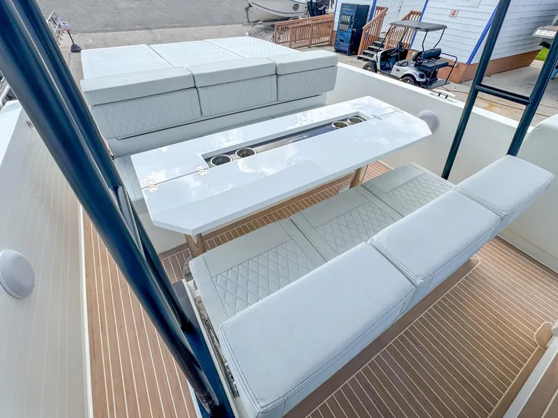 Slide: The Image of 2024 De Antonio Yachts D28 Open interior with sleek seating and modern table design. - 7