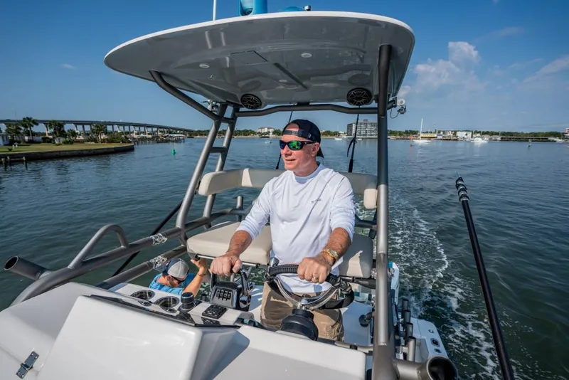 Slide: The Image of Man piloting 2026 Solace 41 CS boat on a sunny day. - 4