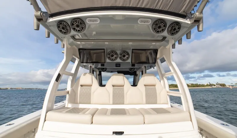 Slide: The Image of 2026 Solace 41 CS boat interior with luxury seating and audio system on the water. - 5