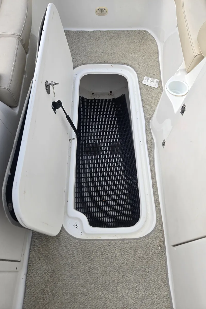 Slide: The Image of Open storage compartment on 2005 NauticStar 210 Sport Deck I/O boat. - 10