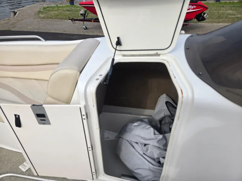 Slide: The Image of Open storage compartment on a 2005 NauticStar 210 Sport Deck I/O boat. - 9