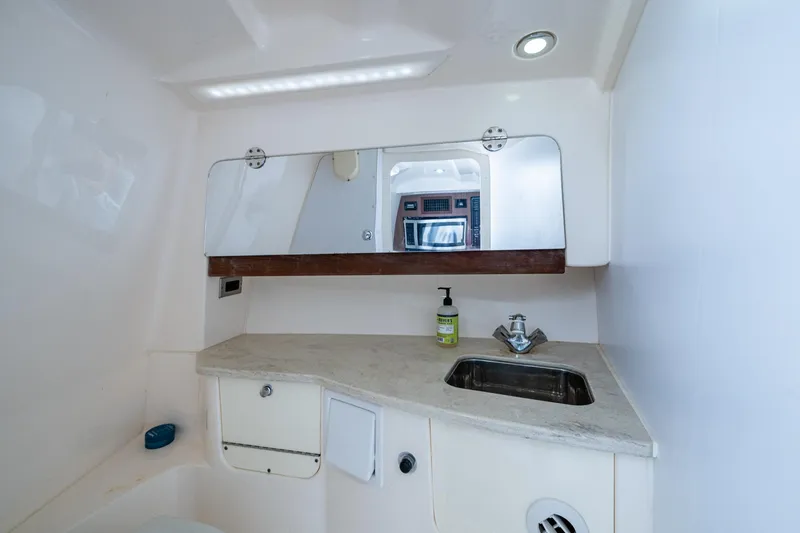 Slide: The Image of 2014 Everglades 350LX boat bathroom with sink, mirror, and countertop. - 10