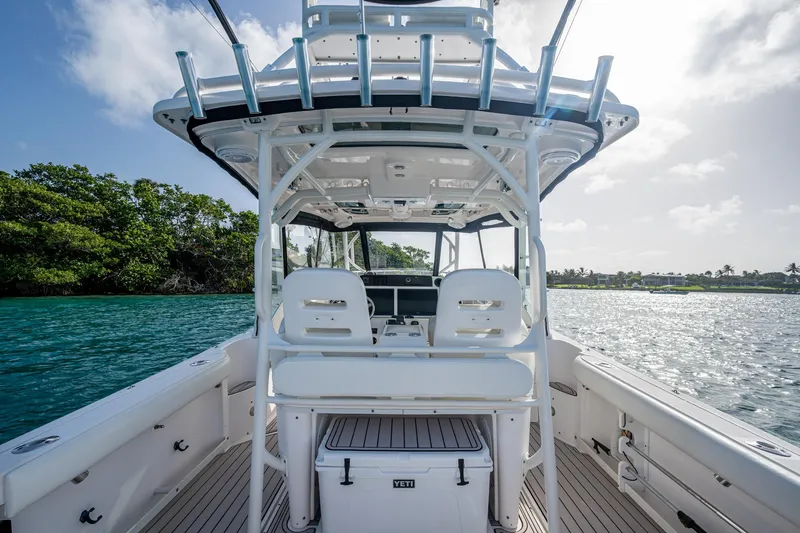 Slide: The Image of 2014 Everglades 350LX boat interior with seating, ocean view, and sunny sky. - 15