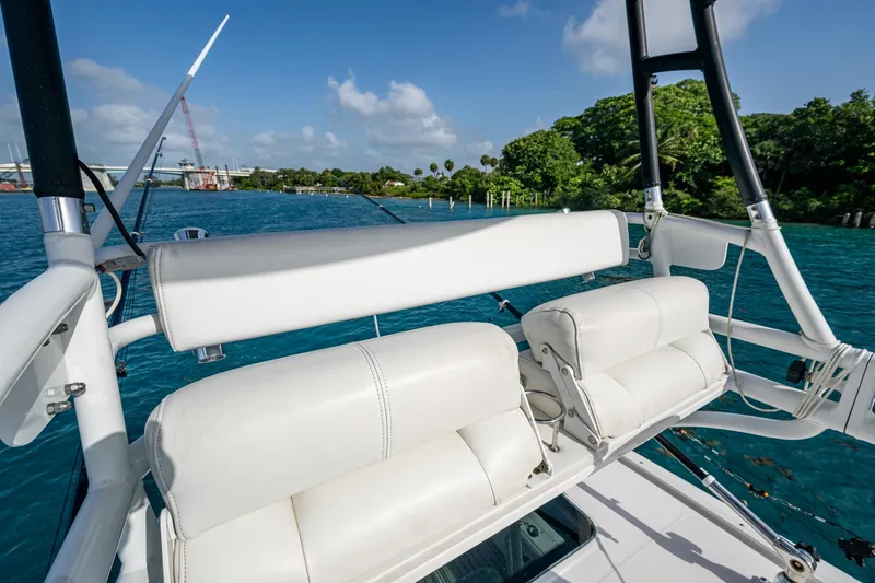 Slide: The Image of 2014 Everglades 350LX boat with white seating, overlooking blue water and lush greenery. - 25