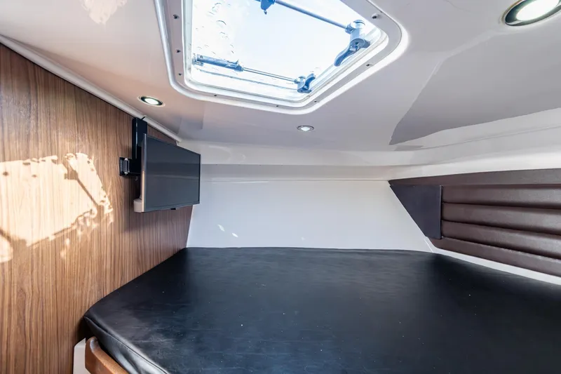 Slide: The Image of Interior cabin of 2014 Everglades 350LX boat with skylight and mounted TV. - 8