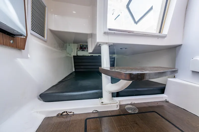 Slide: The Image of 2014 Everglades 350LX cabin interior with wooden flooring and cushioned seating. - 9