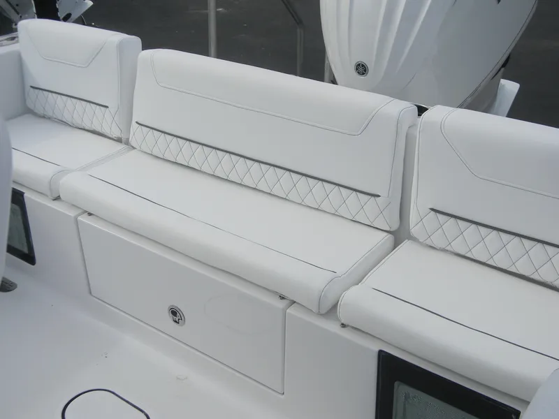 Slide: The Image of White seating on 2025 Sportsman Masters 247OE Bay Boat, featuring diamond-patterned upholstery. - 19
