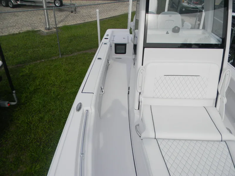 Slide: The Image of 2025 Sportsman Masters 247OE Bay Boat interior with white seating and sleek design. - 21