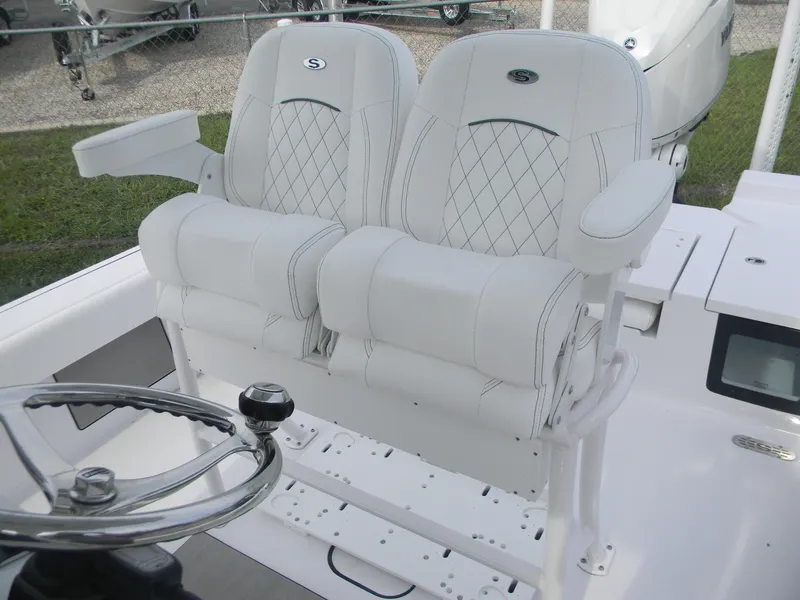 Slide: The Image of 2025 Sportsman Masters 247OE Bay Boat with luxurious white seating and steering wheel. - 22