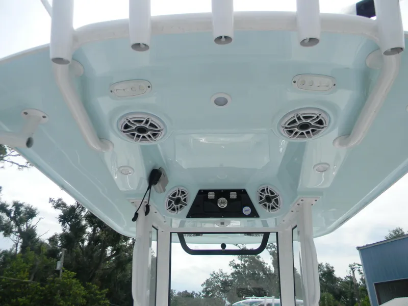 Slide: The Image of 2025 Sportsman Masters 247OE Bay Boat T-top with speakers and rod holders. - 27