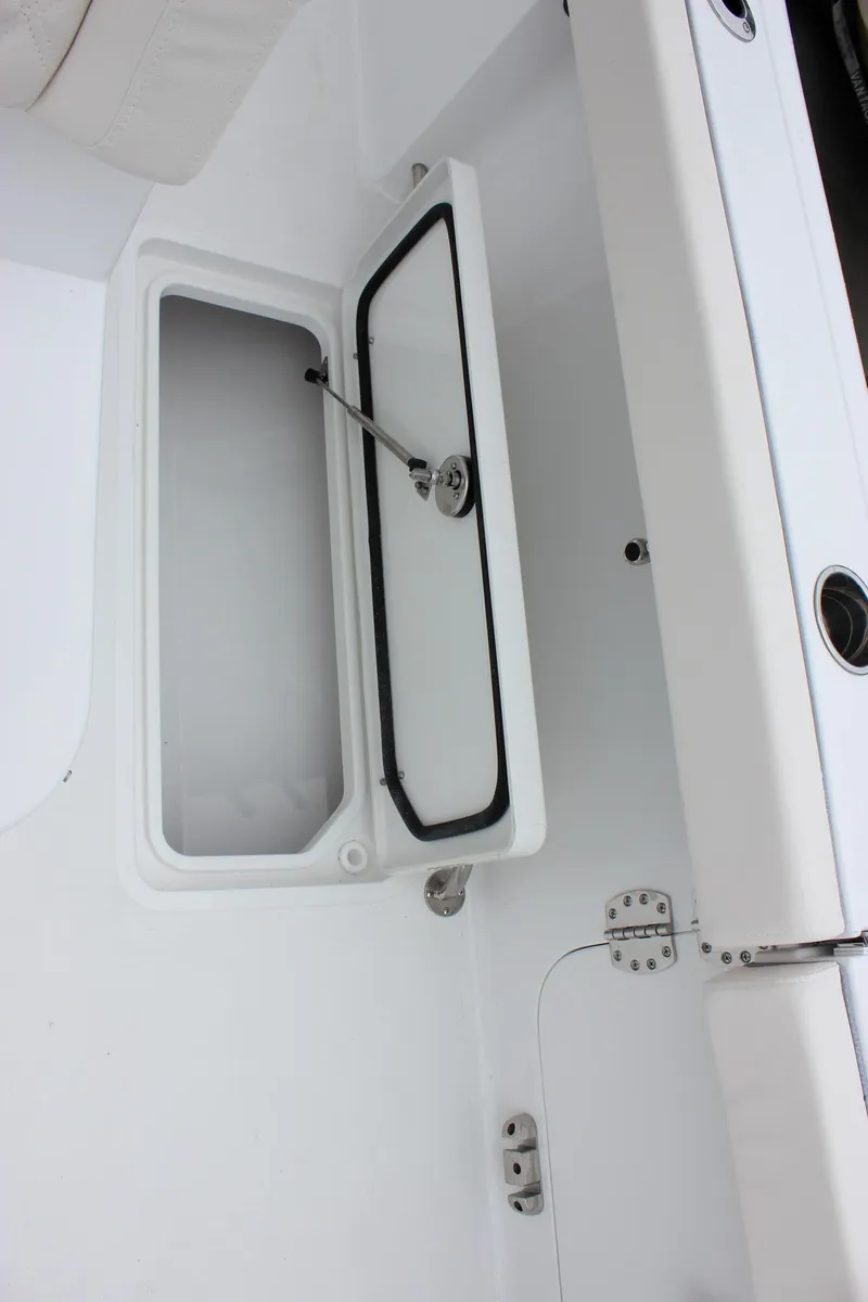 Slide: The Image of Open storage compartment on 2026 Sea Hunt Gamefish 27 Forward Seating boat. - 13