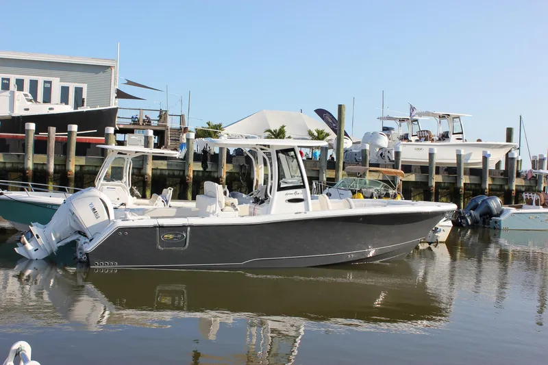 Slide: The Image of 2026 Sea Hunt Gamefish 27 Forward Seating boat docked at marina. - 2