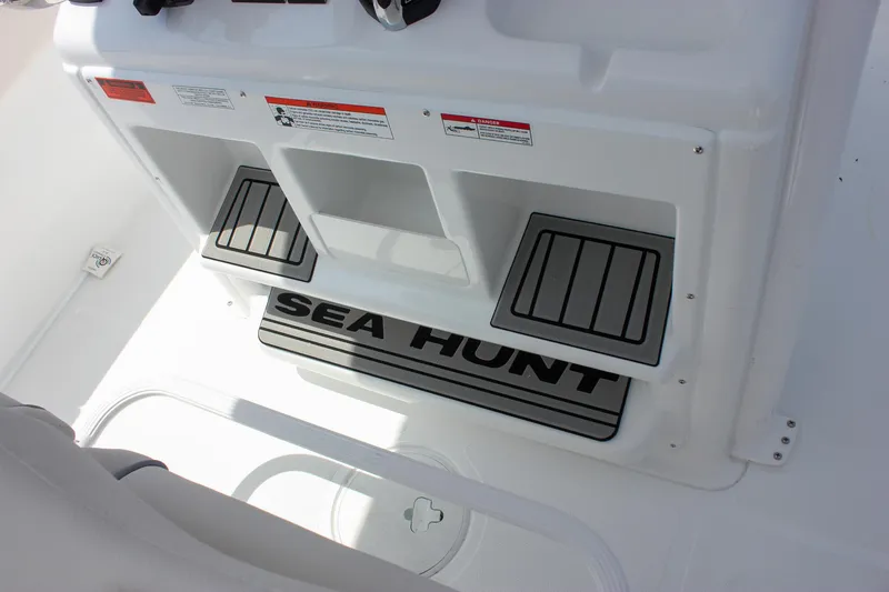 Slide: The Image of 2026 Sea Hunt Gamefish 27 boat interior with forward seating and branded flooring. - 20