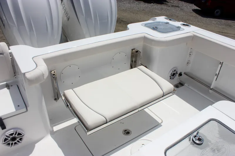 Slide: The Image of 2026 Sea Hunt Gamefish 27 boat interior with foldable seating and storage compartments. - 23