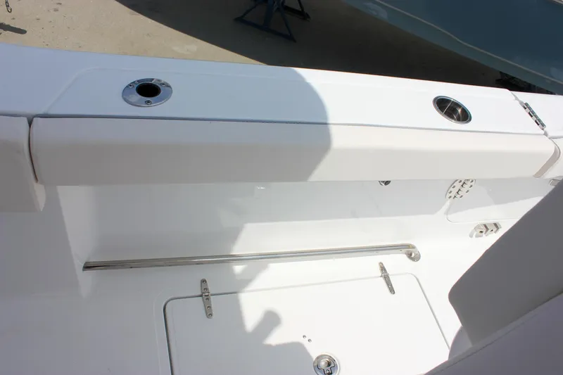 Slide: The Image of 2026 Sea Hunt Gamefish 27 Forward Seating, white interior with rod holders and storage compartment. - 24