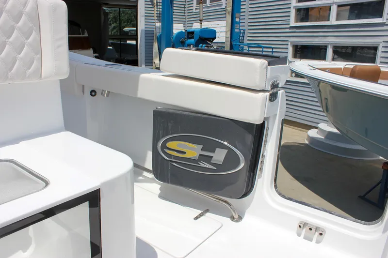 Slide: The Image of 2026 Sea Hunt Gamefish 27 Forward Seating boat interior with logo and seating details. - 27