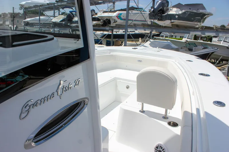 Slide: The Image of 2026 Sea Hunt Gamefish 27 Forward Seating boat, showcasing sleek design and spacious seating area. - 28