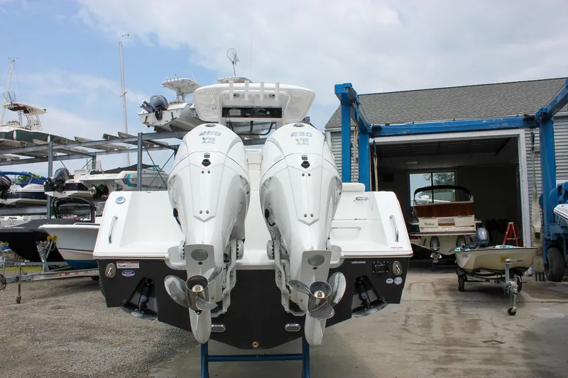 Slide: The Image of 2026 Sea Hunt Gamefish 27 with dual outboard motors in a boatyard setting. - 4