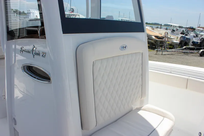 Slide: The Image of 2026 Sea Hunt Gamefish 27 Forward Seating boat with white cushioned seating. - 45