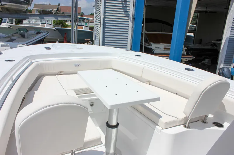 Slide: The Image of 2026 Sea Hunt Gamefish 27 Forward Seating with white cushioned seats and table. - 46