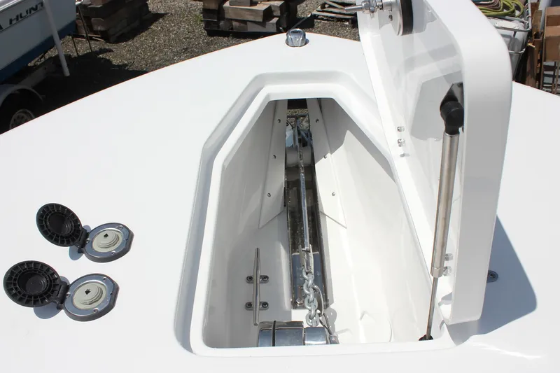 Slide: The Image of Anchor compartment of 2026 Sea Hunt Gamefish 27 Forward Seating boat, open hatch view. - 47