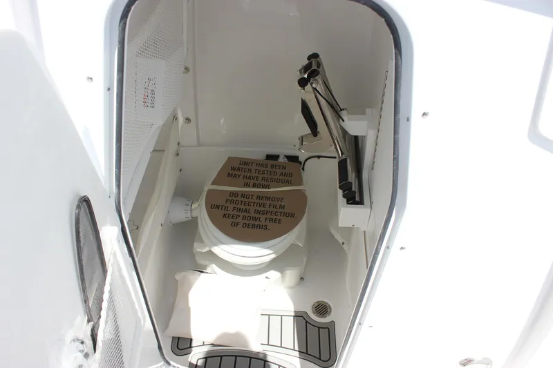 Slide: The Image of 2026 Sea Hunt Gamefish 27 Forward Seating boat interior with toilet and protective cover. - 49