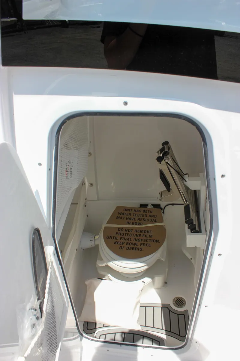 Slide: The Image of 2026 Sea Hunt Gamefish 27 Forward Seating boat interior with compact marine toilet. - 50