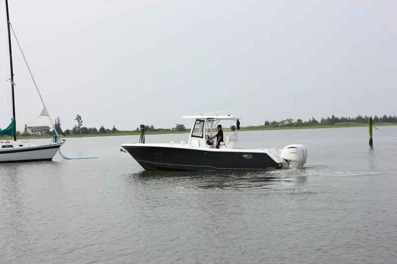 Slide: The Image of 2026 Sea Hunt Gamefish 27 Forward Seating boat cruising on calm waters. - 61