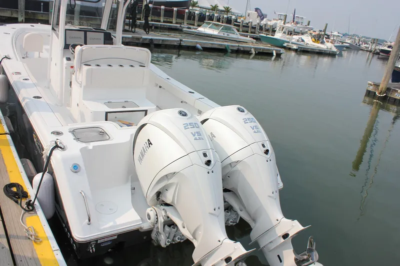 Slide: The Image of 2026 Sea Hunt Gamefish 27 boat with twin Yamaha 250 engines docked at marina. - 62