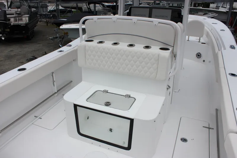 Slide: The Image of 2026 Sea Hunt Gamefish 27 Forward Seating boat interior with white seating and storage. - 8