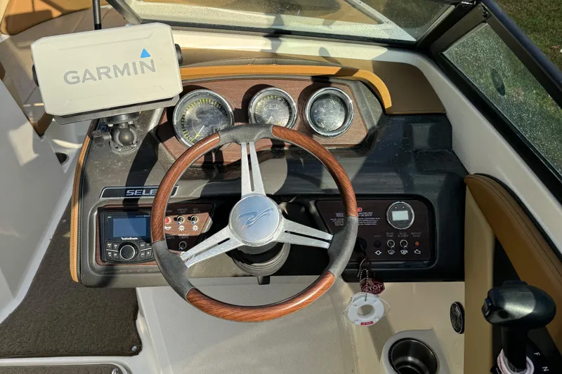 Slide: The Image of Steering wheel and dashboard of 2017 Sea Ray SPX 190 boat with Garmin navigation system. - 2