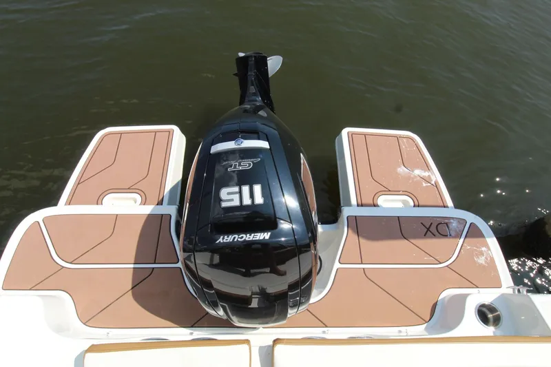 Slide: The Image of 2022 Bayliner DX2000 boat with Mercury outboard engine on water. - 15