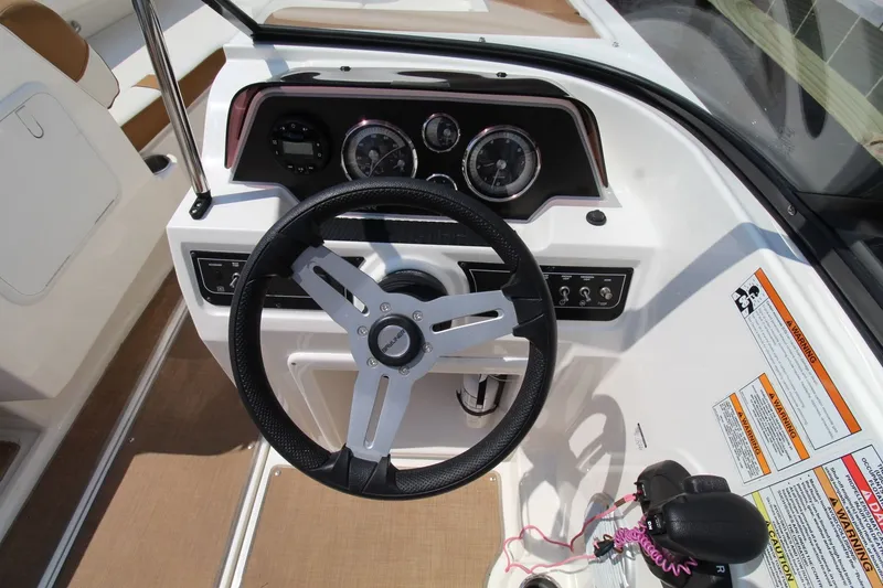 Slide: The Image of 2022 Bayliner DX2000 boat dashboard with steering wheel and control panel. - 20