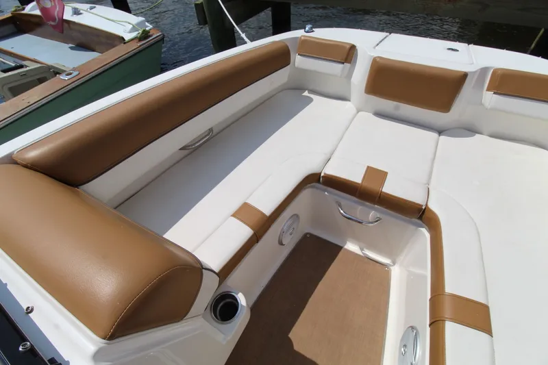Slide: The Image of 2022 Bayliner DX2000 boat interior with tan and white seating. - 23