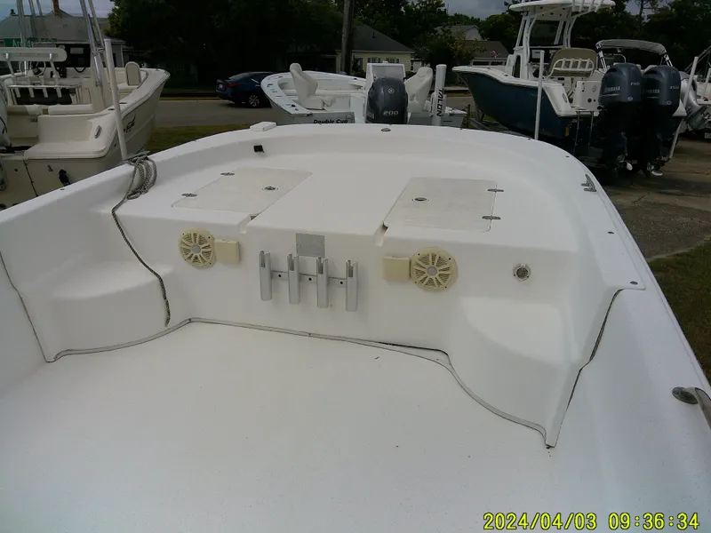 Slide: The Image of 2010 Carolina Skiff 238 DLV boat deck with storage compartments and rod holders. - 10